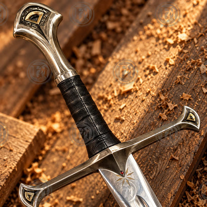 Close-up of Anduril dagger hilt showing black grip, silver crossguard and gold decorative accents