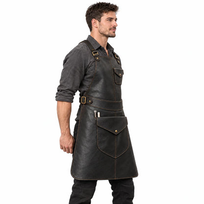 Side profile of male model wearing the Anvil Arc blacksmith leather apron with waist buckles and large front flap pocket.