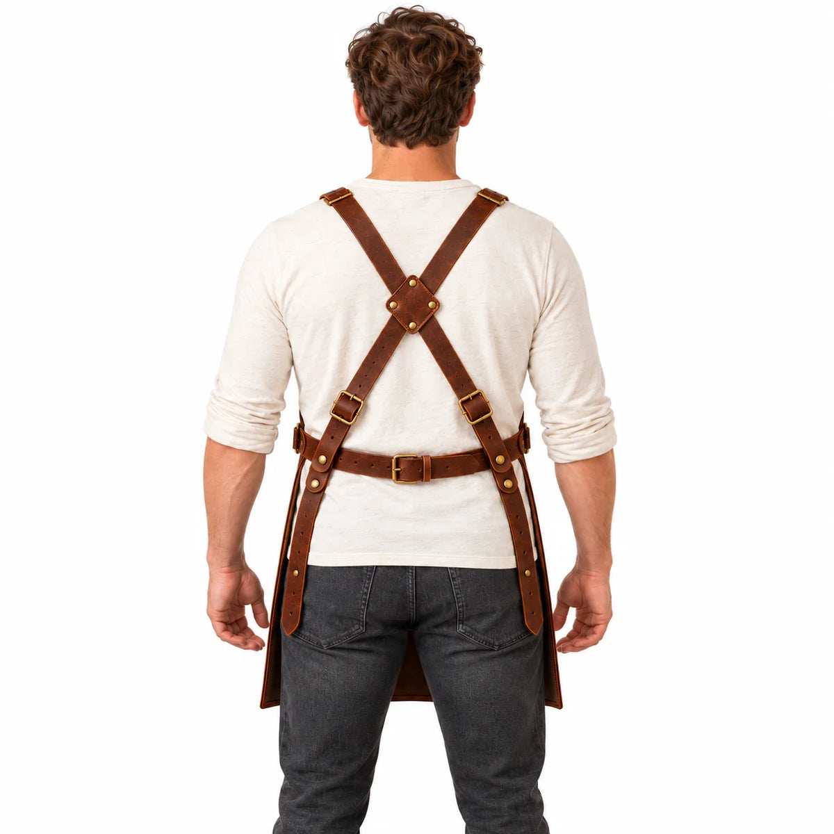 Back view of male model demonstrating the adjustable cross-back harness and buckled waist fastening of a brown leather apron.
