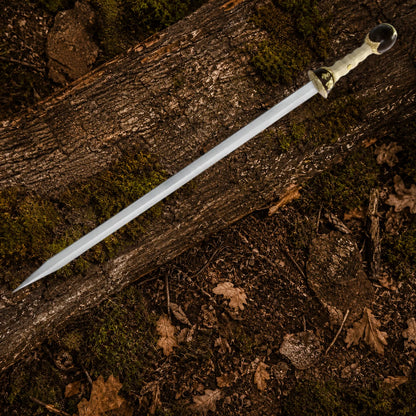 Full-length Gladiator Maximus Roman sword replica arranged diagonally on woodland bark, showing its silver blade and ornate ivory-style handle