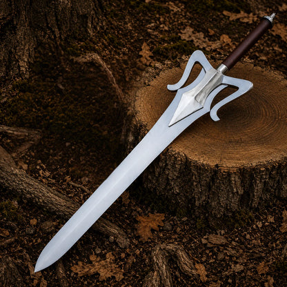Full He-Man 1987 fantasy display sword laid diagonally across a woodland stump showing its broad silver blade