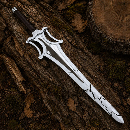 Full-length fractured fantasy sword resting diagonally across textured woodland bark and moss