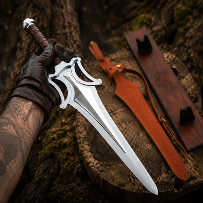 Gloved collector holding the silver He-Man Power Sword above a woodland stump with sheath and plaque behind