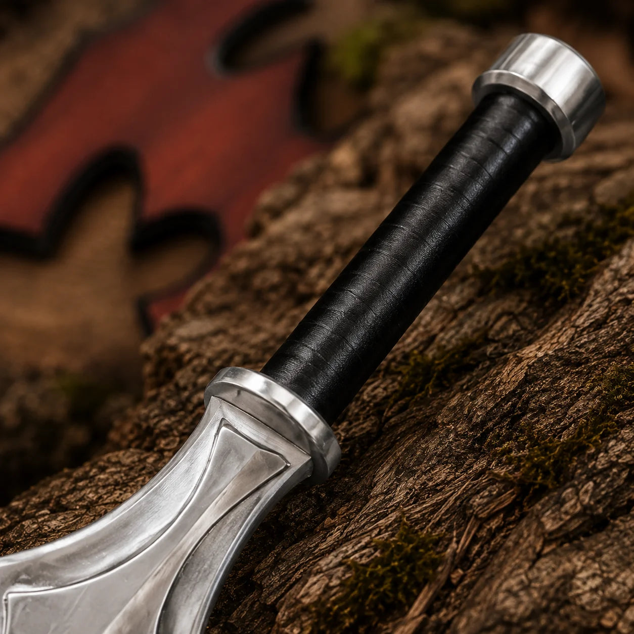 Close-up of the He-Man Power Sword black wrapped grip, silver pommel and sculpted geometric hilt detail