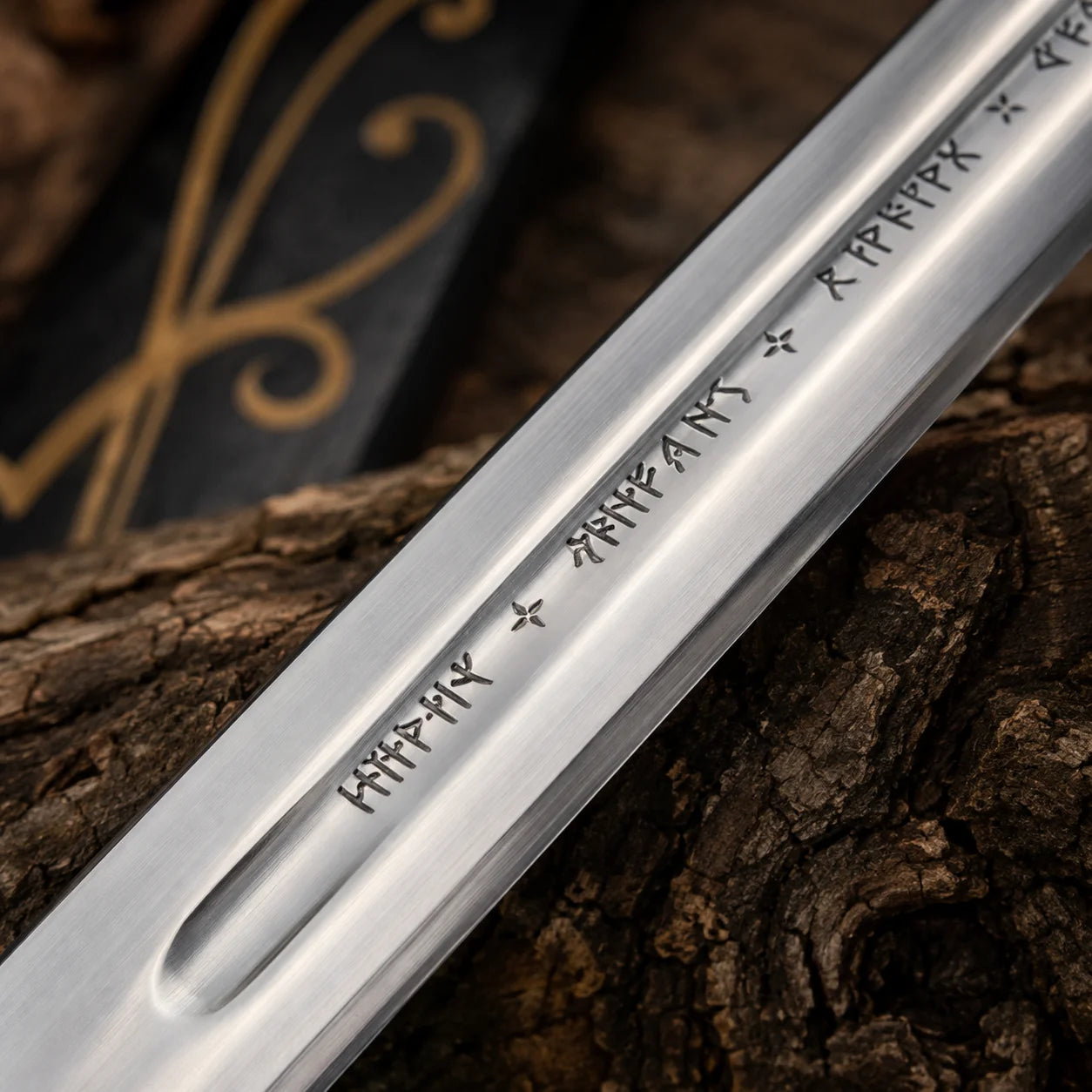 Detailed Anduril sword blade close-up showing polished fuller groove and engraved fantasy runes against textured tree bark
