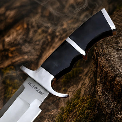 Close-up of the Predator Dutch Schaefer prop handle featuring sculpted black grip, silver accents and curved metal guard