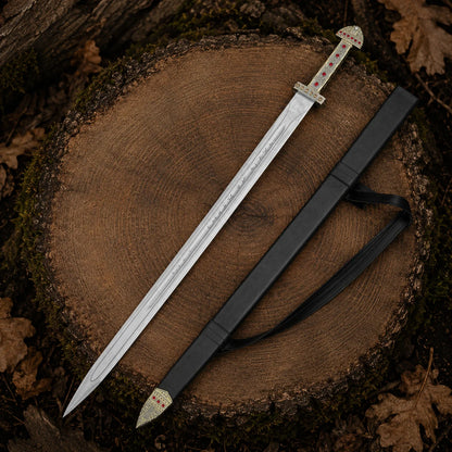 Ragnar Lothbrok Viking sword replica and matching black scabbard displayed together on a woodland tree stump
