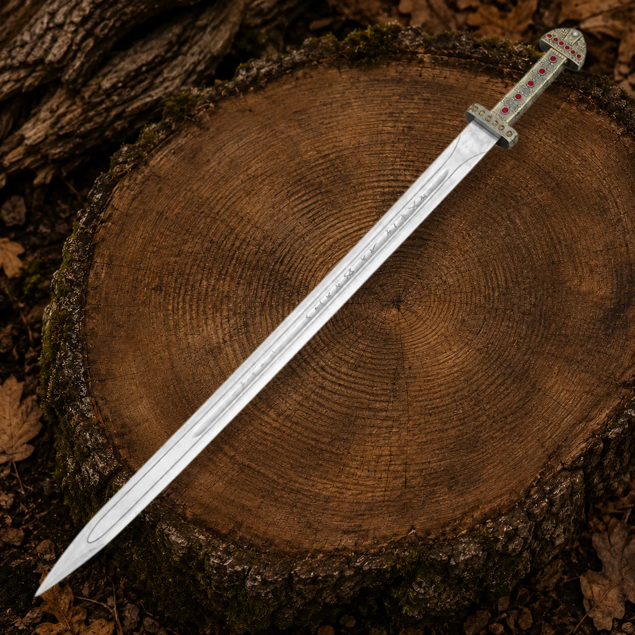 Full-length Ragnar Lothbrok Viking sword with engraved stainless steel blade and ornate red jewel handle on a tree stump