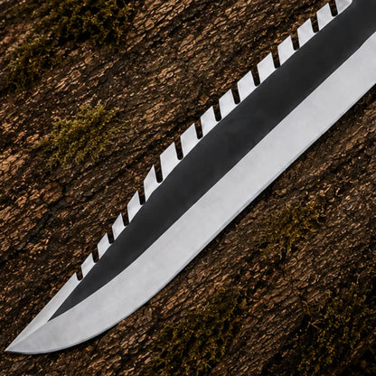 Close-up of the Rambo First Blood Part II matte black blade with silver edge and sawback detailing