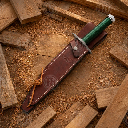 Rambo First Blood knife displayed with brown sheath, compass, matches, hooks, line and survival-themed accessories.