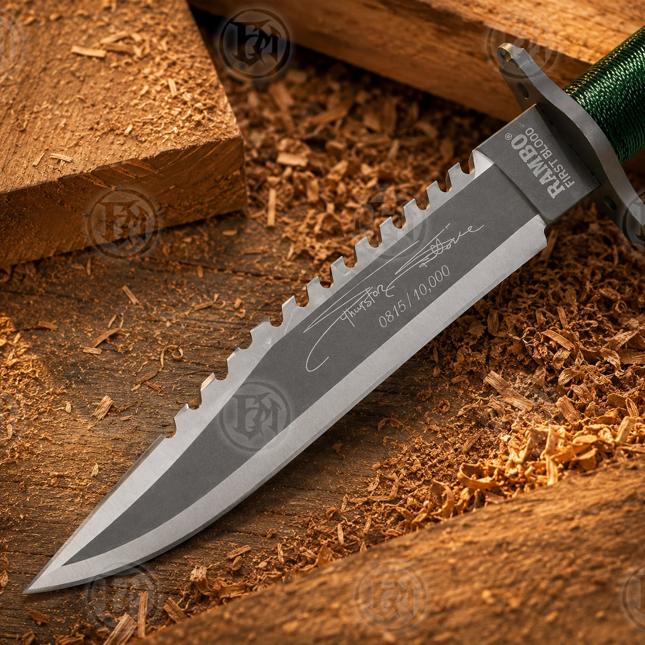 Close-up of green nylon cord handle, stainless guard and silver-toned pommel on the Rambo First Blood knife replica.