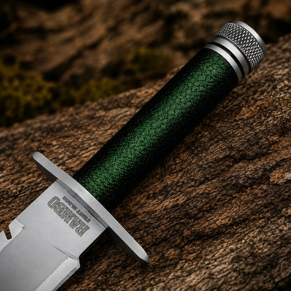 Close-up of the Rambo First Blood Part I replica handle with green cord wrapping, silver guard and textured pommel