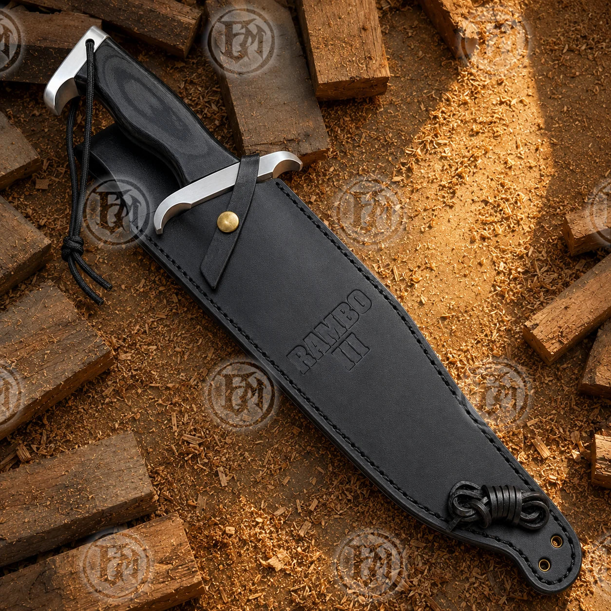 Rambo III replica partially inserted into its black sheath on a rustic wood surface, showing the snap strap and lanyard.