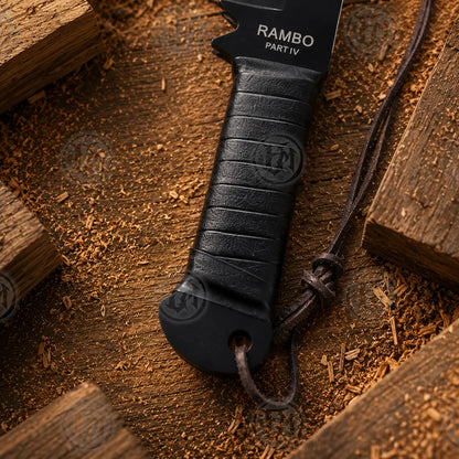 Detailed Rambo Part IV machete handle showing black horizontal wrap, blade marking and dark cord lanyard.
