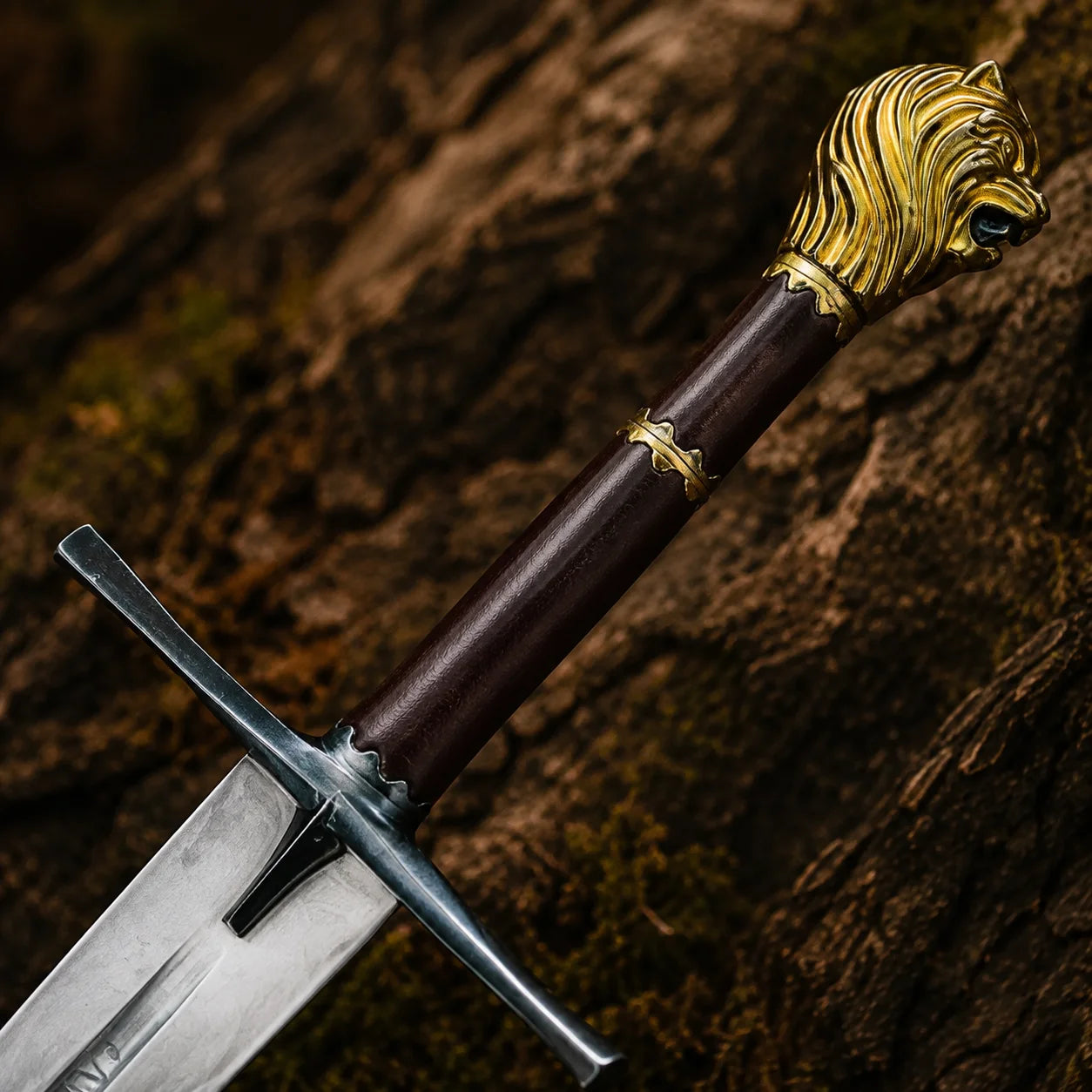 Close-up of the Rhindon Sword handle showing dark rosewood-style grip, black crossguard and detailed gold lion-head pommel