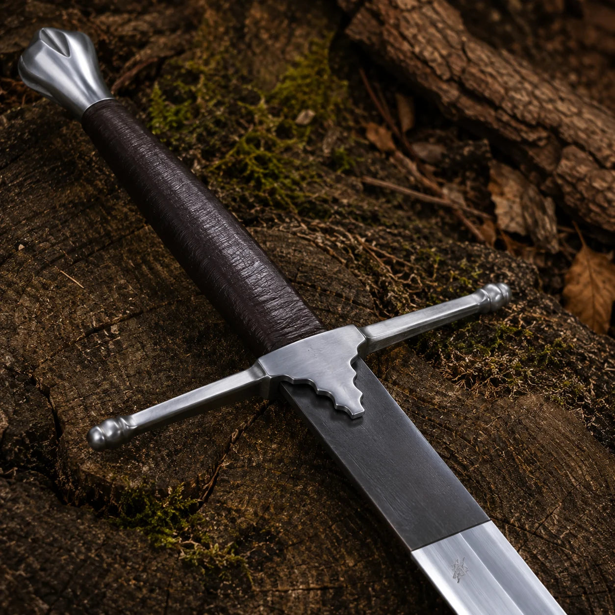 Close-up of the William Wallace Sword handle featuring a dark wrapped grip, silver pommel and straight medieval crossguard