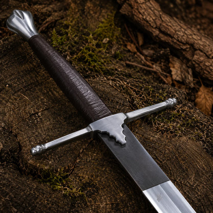Close-up of the William Wallace Sword handle featuring a dark wrapped grip, silver pommel and straight medieval crossguard